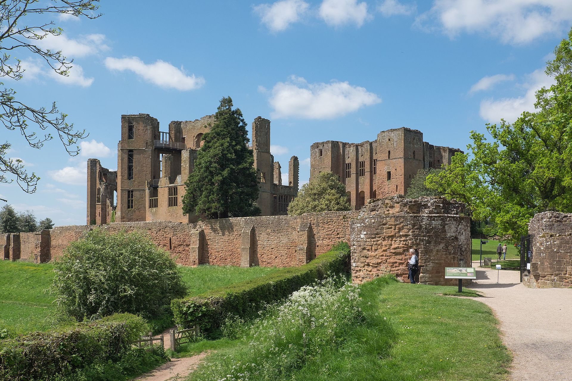 Figure 4 — Kenilworth Castle: the red sandstone ruin of the great keep and Leicester's Building standing in mown grass. Robert Dudley's nineteen-day entertainment for the Queen took place here in July 1575. S…