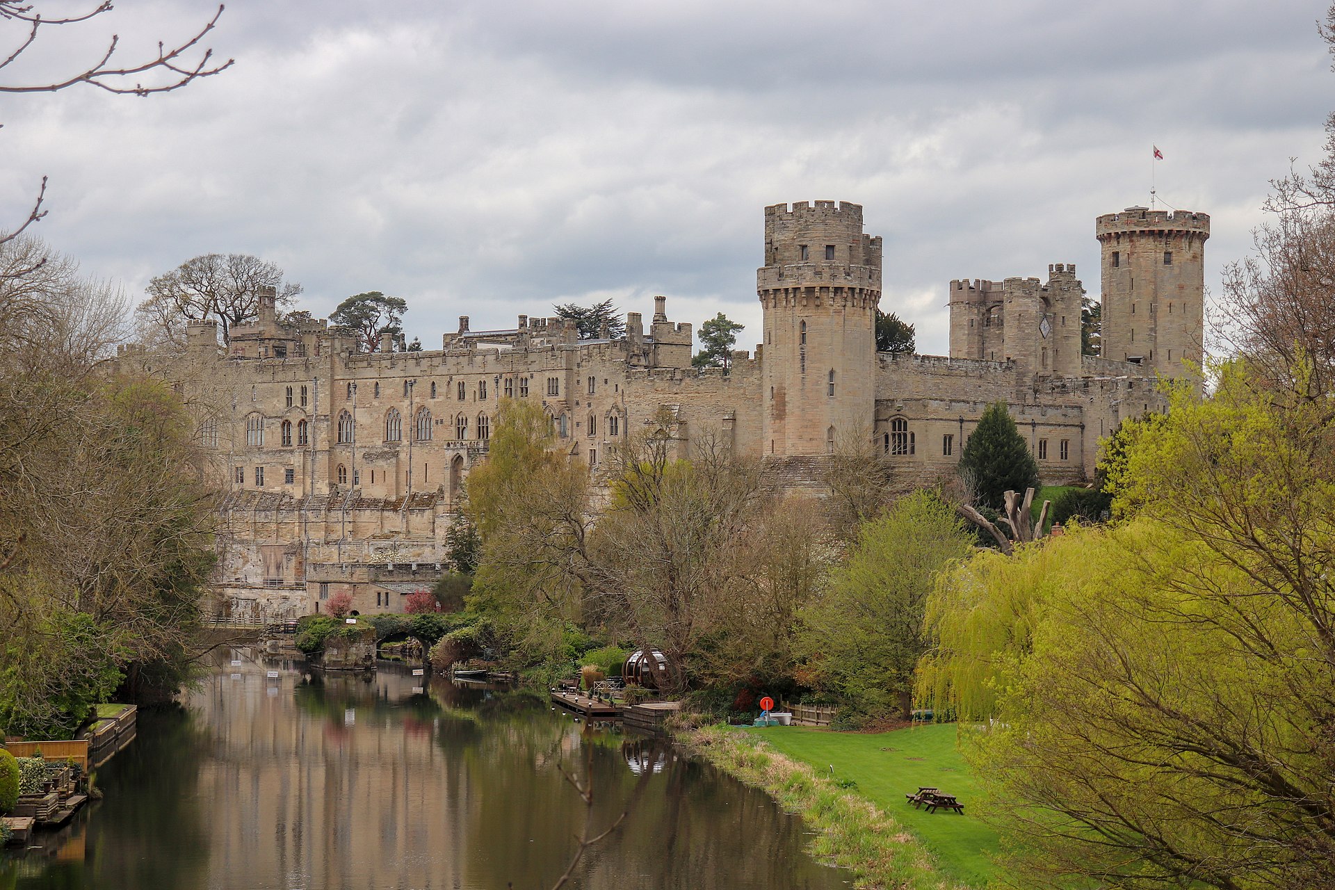 Figure 2 — Warwick Castle seen from Castle Bridge, its towers rising above the wooded bank of the River Avon. The 1572 display was staged along this river, with the town immediately beyond the castle. Source:…