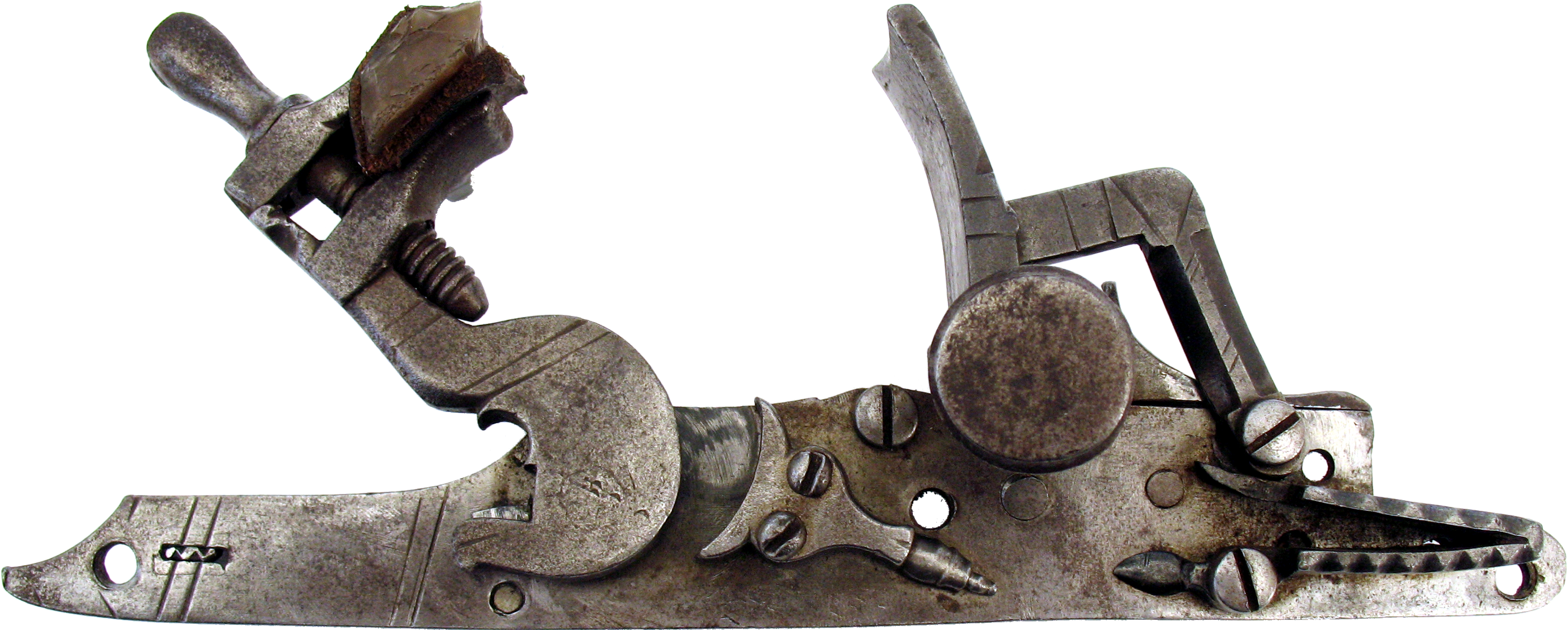 Figure 1 — A snaphance lock isolated against black: the flint clamped in the cock at left, and the separate upright steel — the battery — standing at right, waiting to be struck. The two-piece steel-and-pan-c…