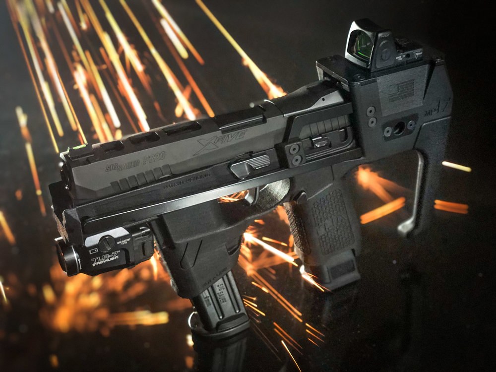 Figure 3 — The MP17 as photographed for Flux's 2019 product page, with a P320 slide, a weapon light and a red dot on the top rail. It is the 2019 product, not the later polymer Raider.