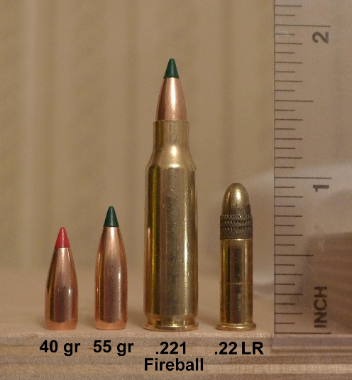 Figure 3 — The .221 Remington Fireball in company. Commons description, verbatim: "L-R: 40 gr Hornady V-Max, 55 gr Sierra BlitzKing, .221 Remington Fireball, .22 LR Remington Golden Bullet." Photo: File:221 R…