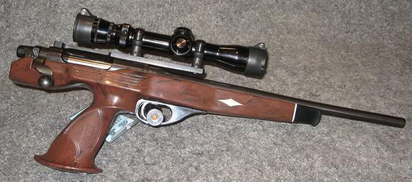 Figure 6 — The XP-100 as most of them are actually used: scoped. The factory drilled and tapped the receiver for exactly this from the first year of production. Photo: File:RemingtonXP-100.jpg, via Wikimedia …