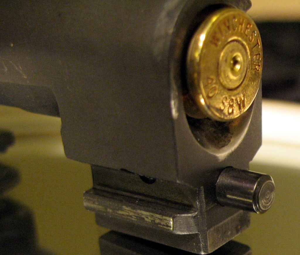 Figure 8 — The breech of a Beretta 96 barrel in .40 S&W, with a fired case in place, photographed to show how much of the case head the chamber supports at the feed-ramp cut. How much of the case is unsupport…
