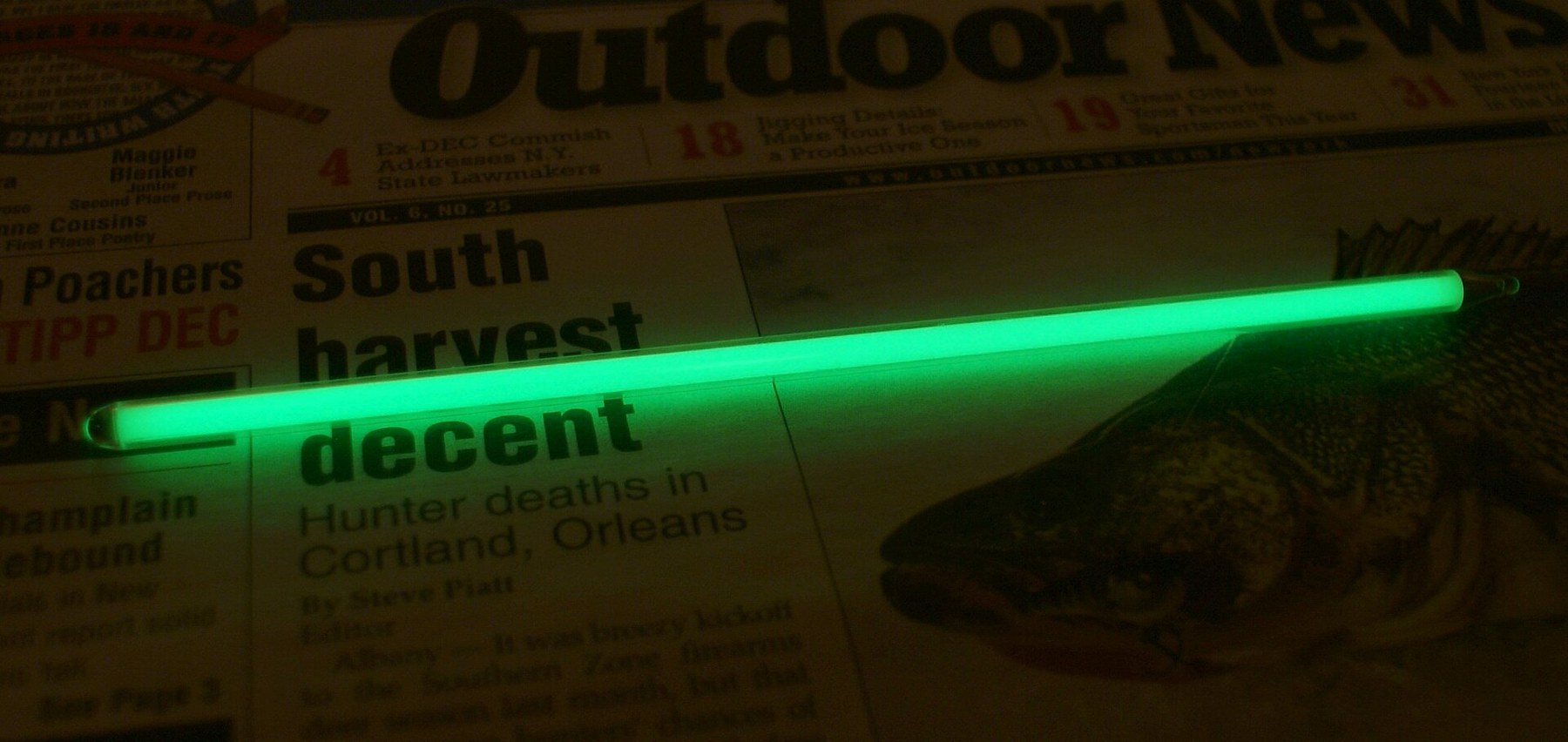 Figure 3 — A gaseous tritium light source — a sealed, phosphor-coated glass tube — glowing on its own. The vials in a pistol sight are the same thing, very much smaller.