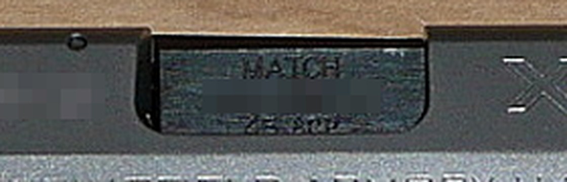 Figure 5 — The barrel hood of the XD(M) at the head of this volume, enlarged. The hood is stamped MATCH above the serial number and the calibre — the most direct evidence available for what the M in the name …