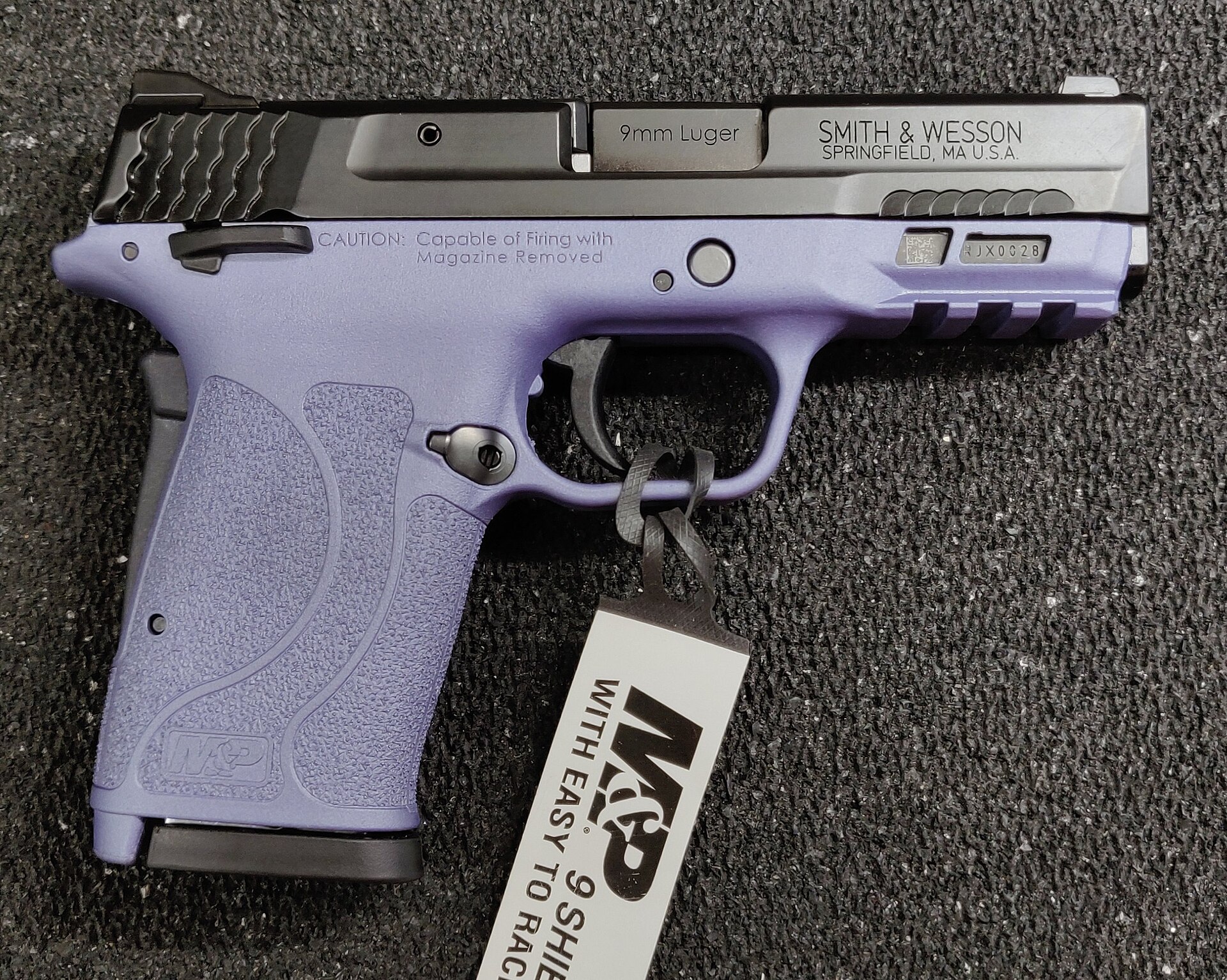 Figure 4 — A Shield EZ in 9 mm. It carries the Shield name and the M&P styling and is not the same mechanism: it is hammer-fired, has a grip safety, and has its own magazines. It is shown here so that it is n…