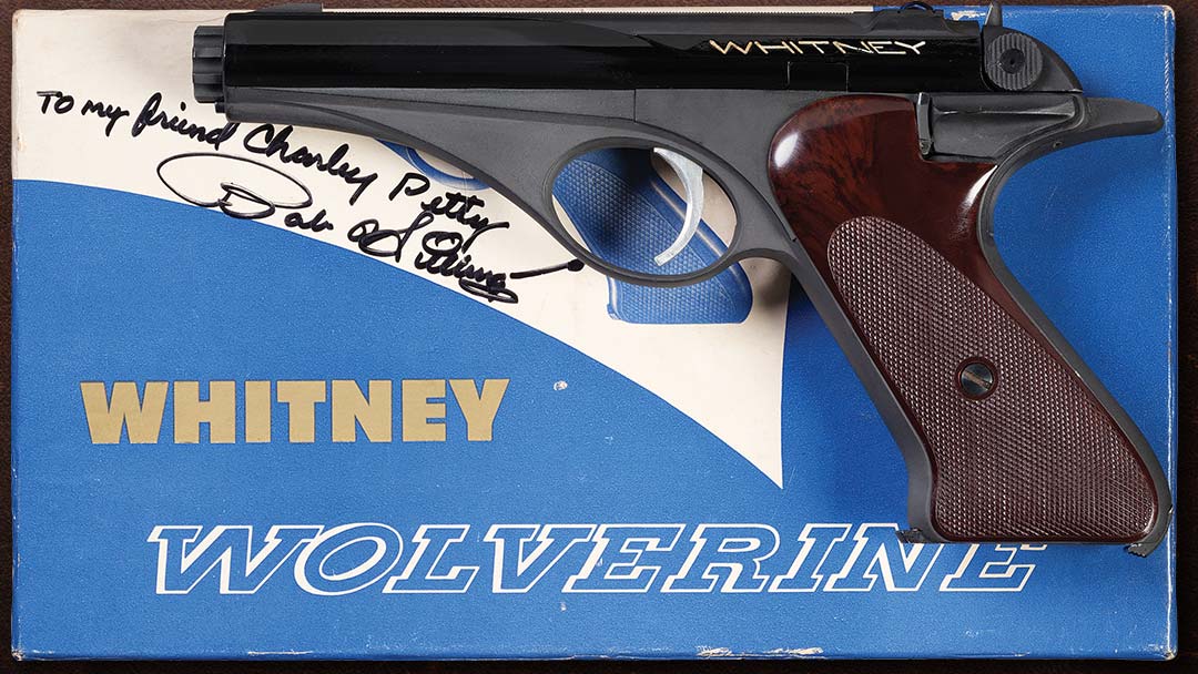 Figure 1 — A Whitney pistol in the black-and-grey anodized finish with its original picture box, which carries a dedication in marker: "To my friend Charley Petty / Bob Hillberg". Charles E. Petty Jr. wrote a…