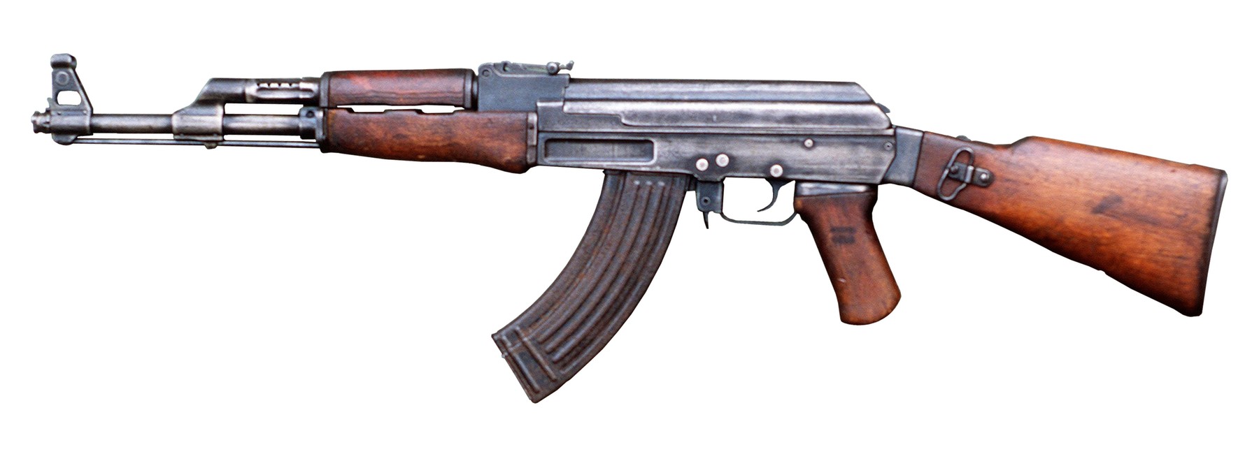 Figure 1 — A Soviet AK with a milled receiver, photographed in profile against a plain background. Almost everything that defines the type is visible here: the long gas tube riding above the barrel, the curve…