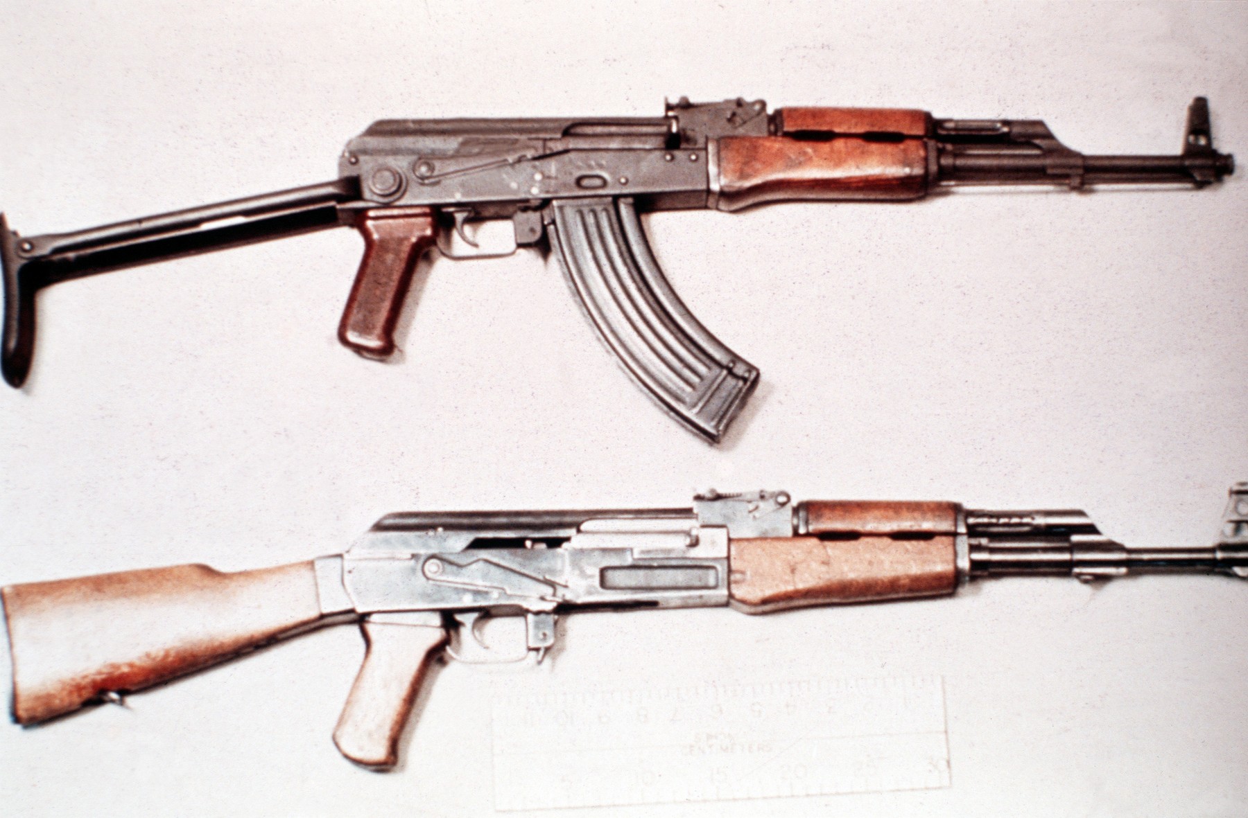 Figure 2 — An AKM above an AK-47 in a US Department of Defense reference photograph — in this case the underfolding AKMS. The muzzle, the receiver surface and the stock angle are the differences to look for.
