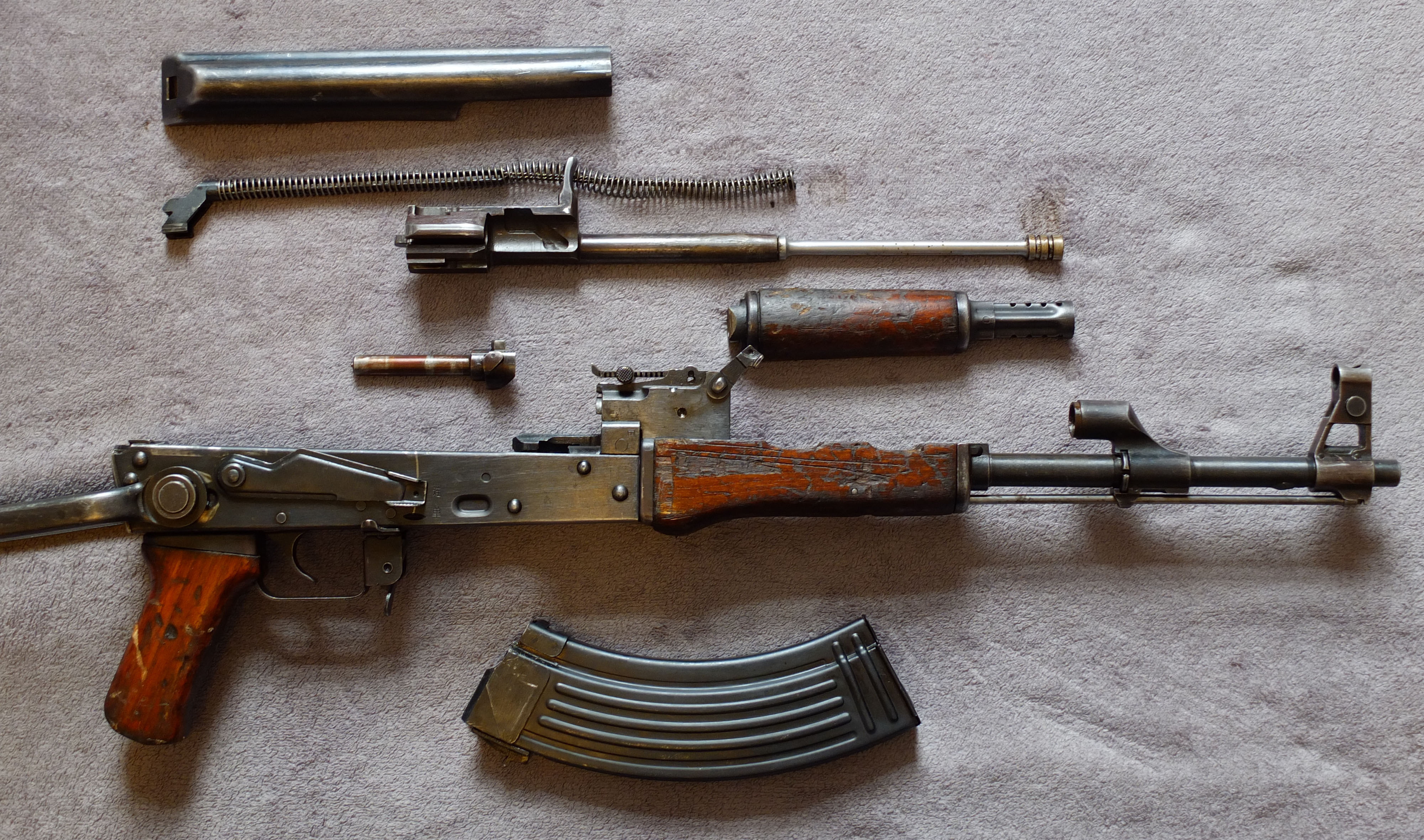 Figure 2 — A Type 56-1 field-stripped to its main groups. Mechanically this is a Kalashnikov like any other; the differences that identify it as Chinese are almost all on the outside.