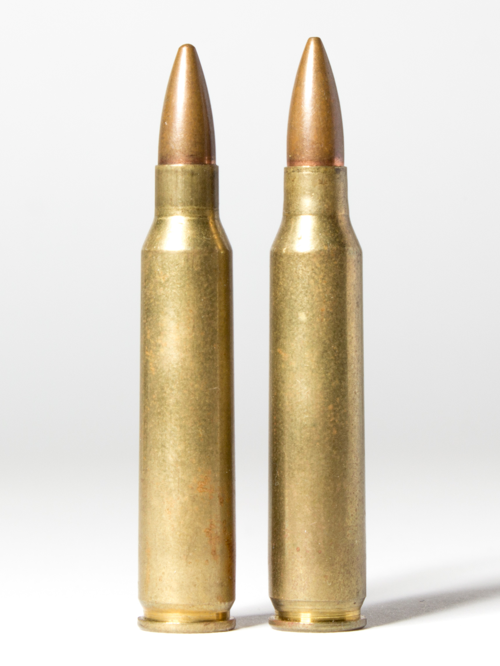 Figure 1 — .223 Remington on the left, 5.56×45mm NATO on the right. Photographed together at the same scale, the two cartridges are dimensionally the same object. Everything that matters about the distinction…