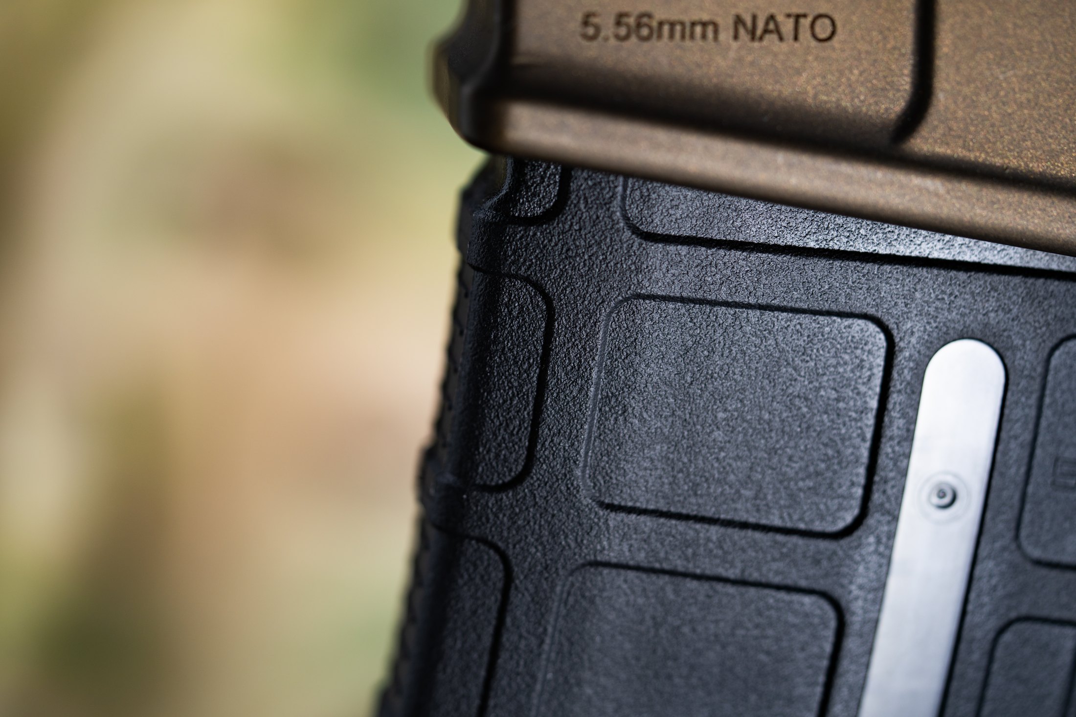 Figure 4 — A magazine seated in an AR-15, with the 5.56mm NATO marking on the magazine body legible. A marking on a magazine describes what the magazine was made for, not what the barrel is chambered for — Vo…