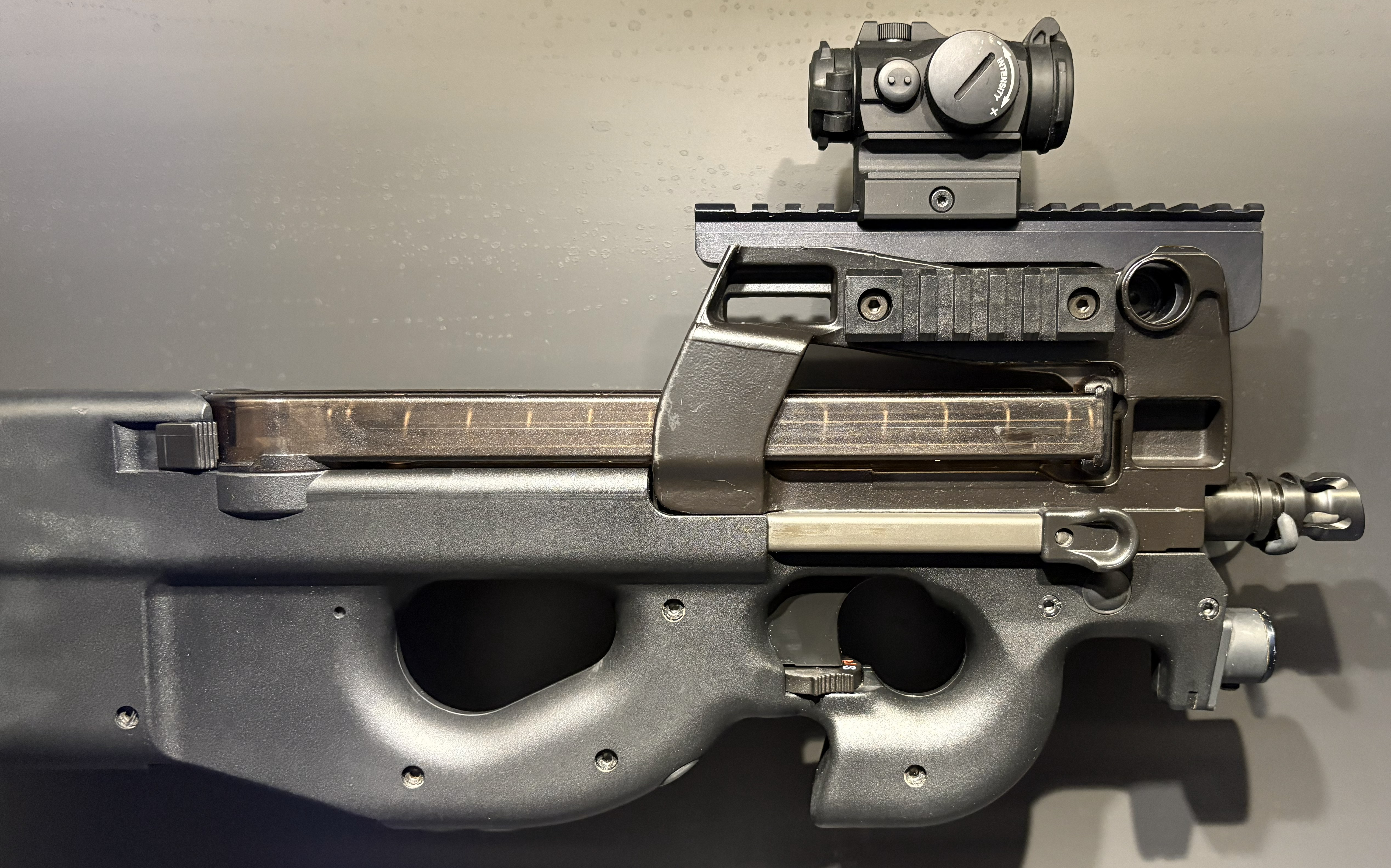 Figure 6 — The muzzle end of a P90 with the front rail fitted. Any suppressor conversation starts at the muzzle, and on a PS90 it starts with measuring a thread this dive could not verify from published sources.