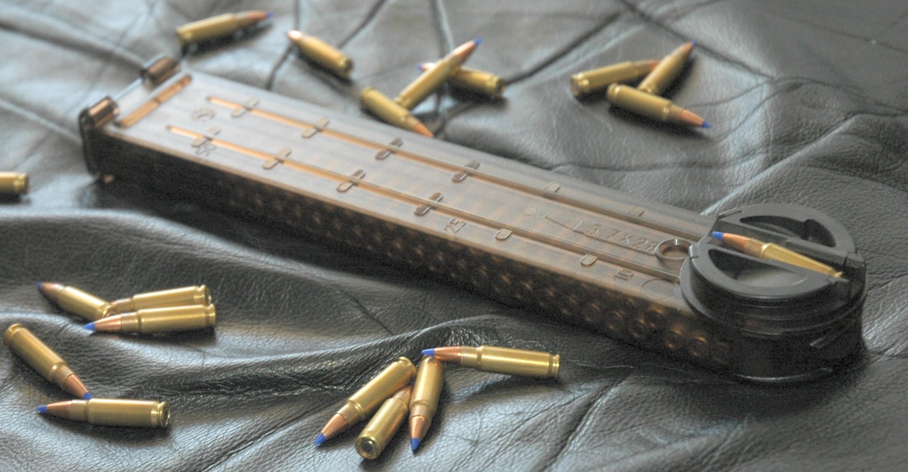 Figure 2 — A P90 magazine out of the weapon with loose cartridges. The length of the body and the transverse orientation of the rounds are both visible — this is a very different object from a conventional bo…
