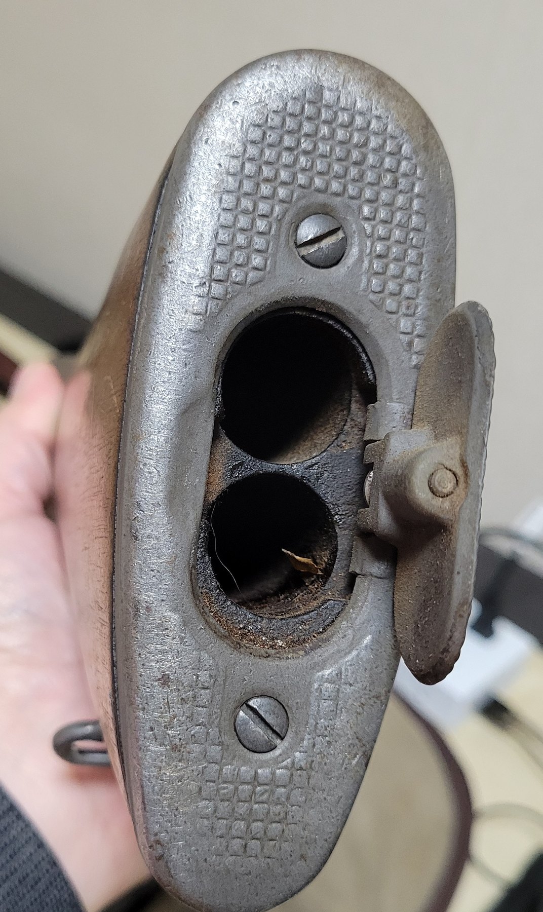 Figure 12 — The buttplate with its trapdoor open, showing the two holes bored into the stock for the cleaning kit. Both were empty.