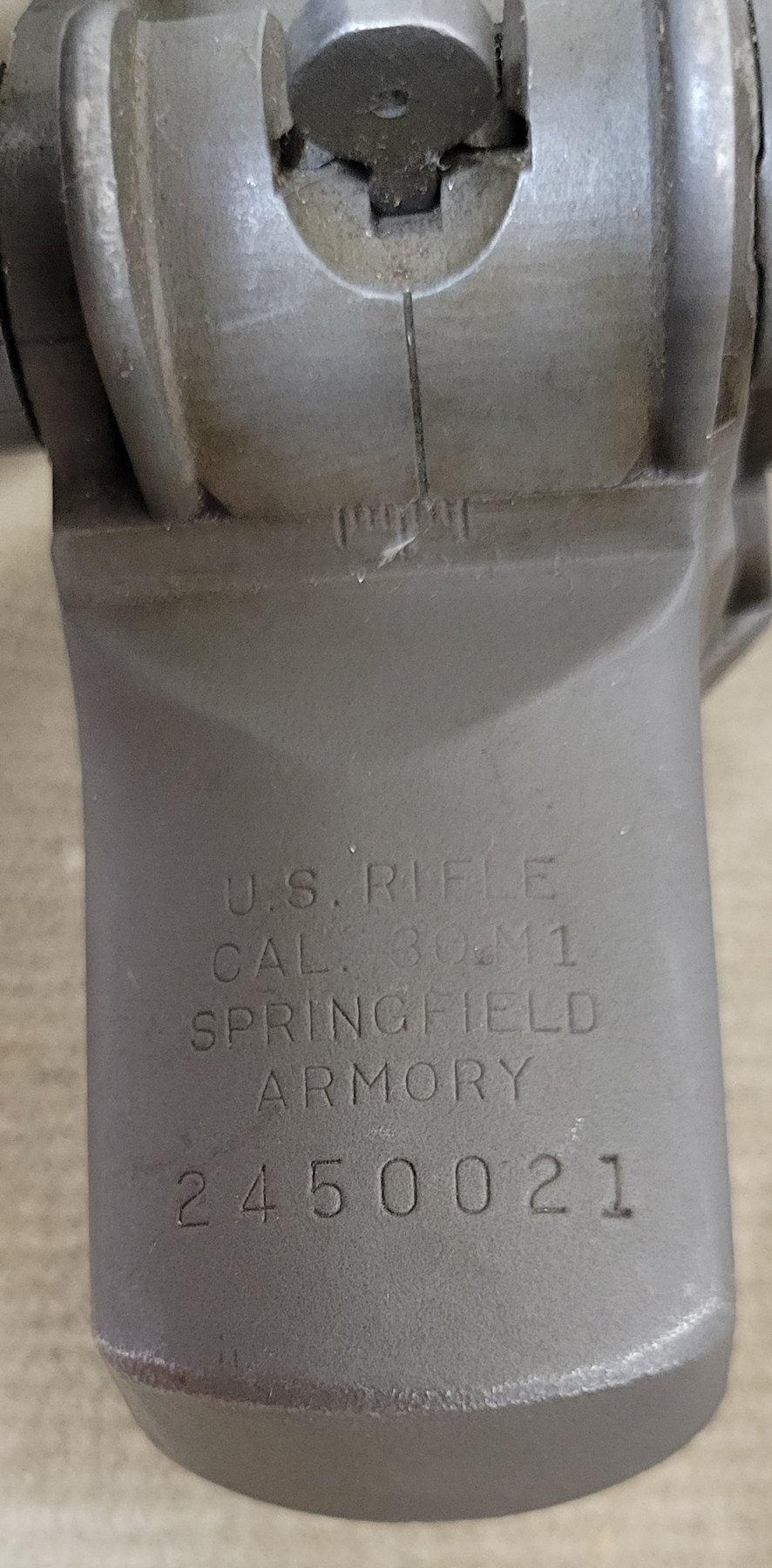 Figure 2 — The receiver heel: U.S. RIFLE / CAL. .30 M1 / SPRINGFIELD ARMORY / 2450021. Photographed straight on from below to check for a hand-stamped "A" after or beneath the serial number, which the Army ap…