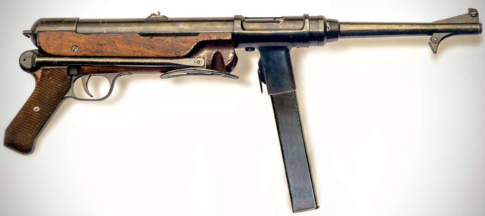 Figure 4 — The Erma MP 36 prototype. The external form of the MP 38 and MP 40 is already present — pistol grip, folding stock, forward magazine well — on a weapon that predates the army requirement it would e…