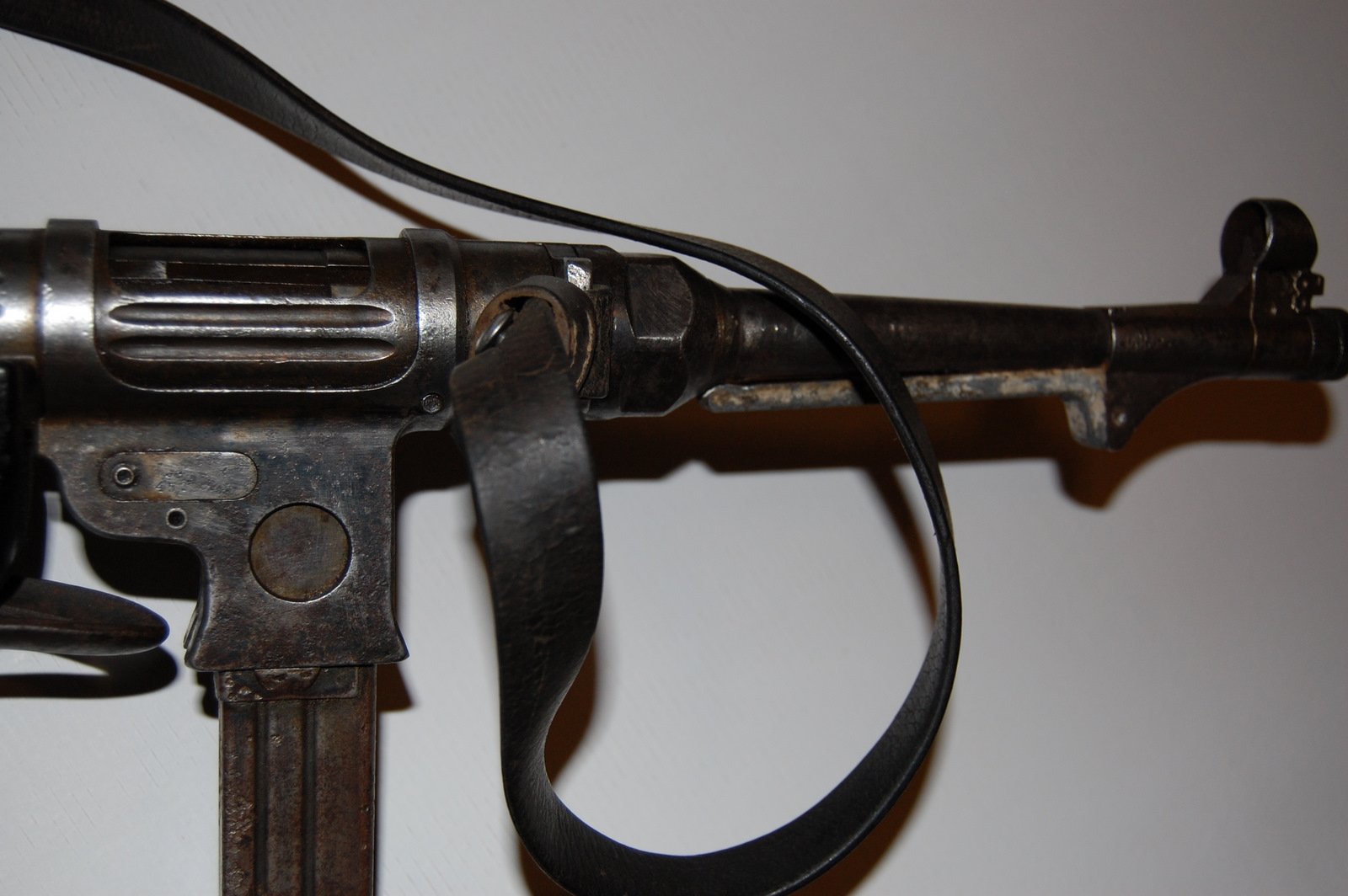 Figure 4 — The MP 38's magazine housing, smooth-sided. Against a well-lit specimen the difference from the MP 40 is unmistakable; in a wartime photograph taken at an angle it frequently is not.