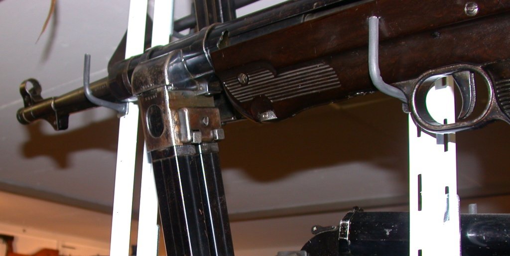 Figure 11 — The dual magazine housing of the MP 40/I. A sliding block carries two ordinary 32-round magazines; one feeds while the other waits, and the block slides across to change from one to the other witho…