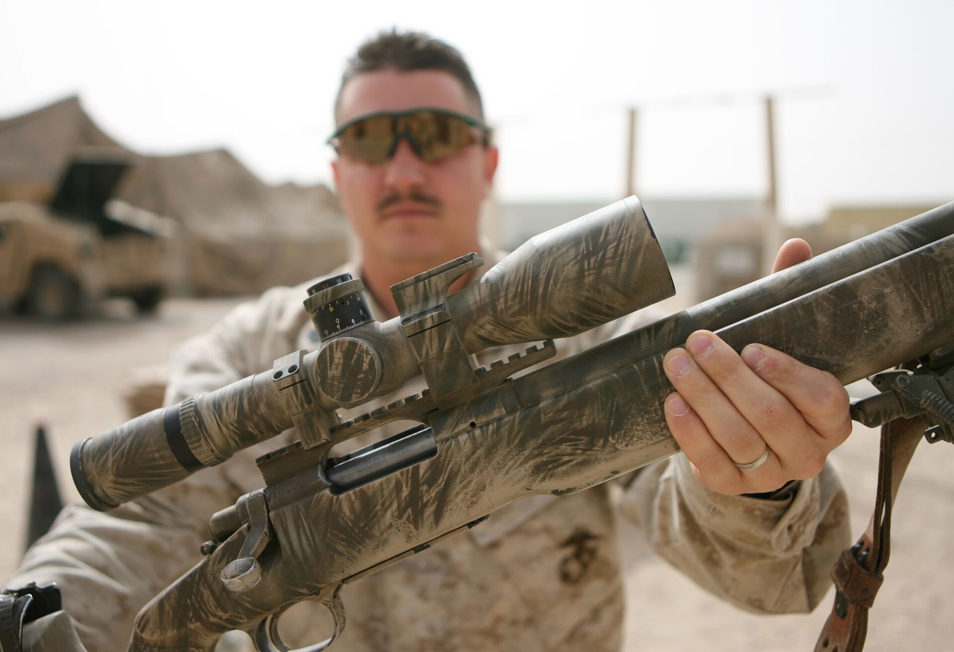 Figure 5 — Gunnery Sgt. Paul Starner, 3rd Battalion, 5th Marines, with the Schmidt & Bender day scope on his M40A3, Camp Mercury, Iraq, 9 March 2006. The stock's field paint and the A-4's adjustable cheekpiec…