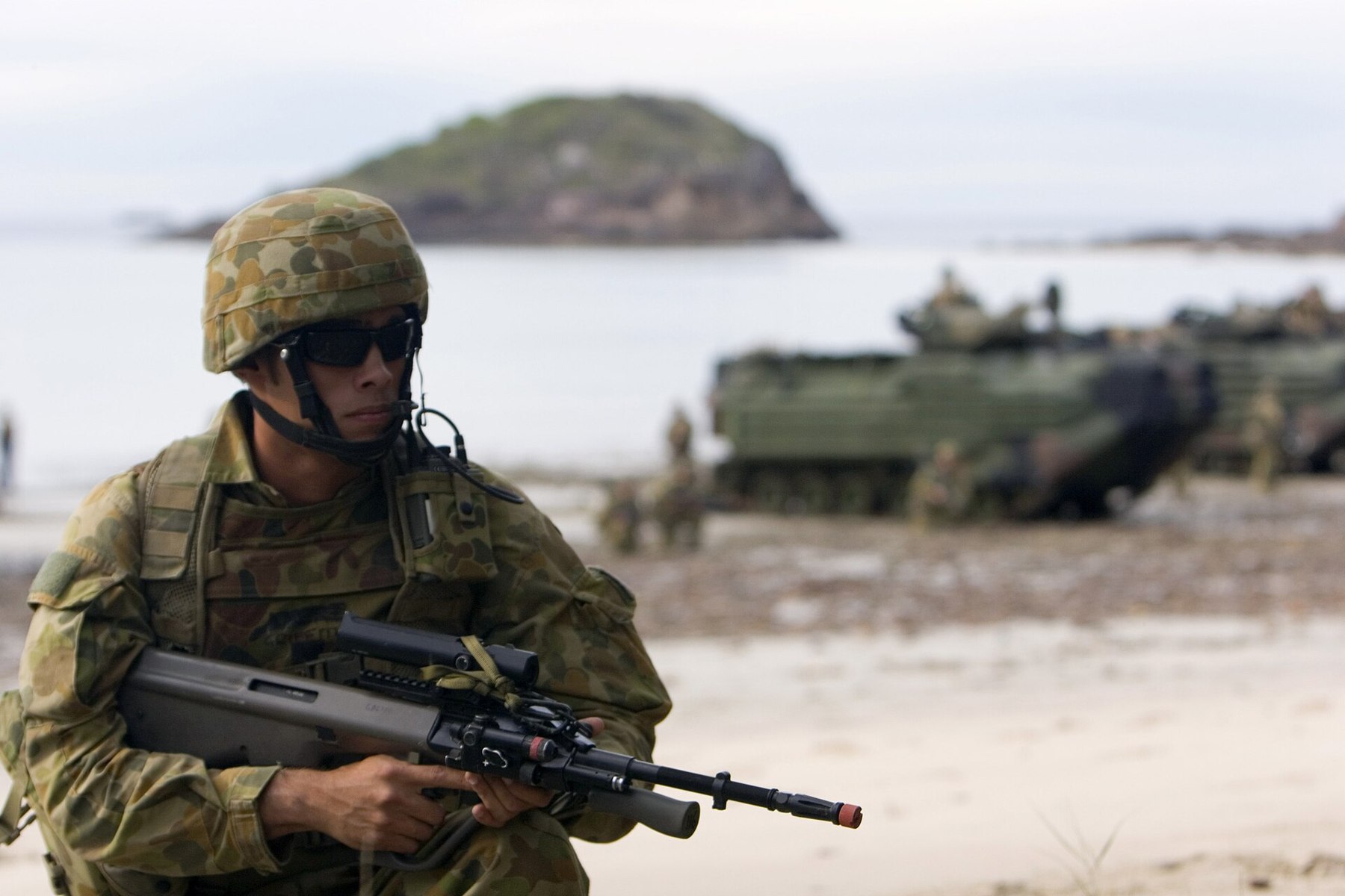 Figure 7 — An F88 with a Picatinny rail and optic in place of the integral sight, carried by a soldier of 2nd Battalion, Royal Australian Regiment, during an amphibious exercise at Shoalwater Bay in 2007. Pho…