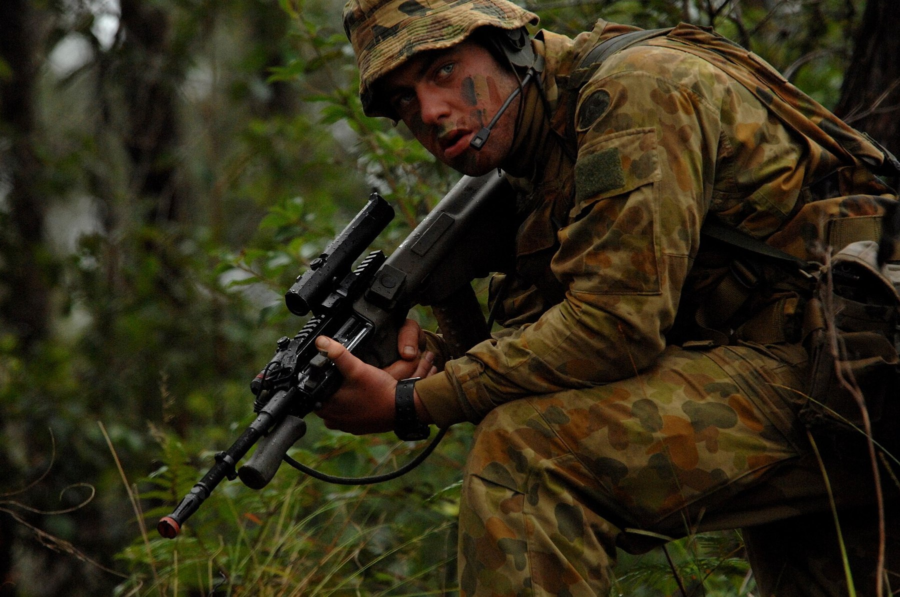 Figure 6 — An Australian soldier of the 2nd Battalion, Royal Australian Regiment, on patrol during Talisman Sabre 2007 with an F88 carrying a Picatinny rail, optic and light in place of the integral sight — t…