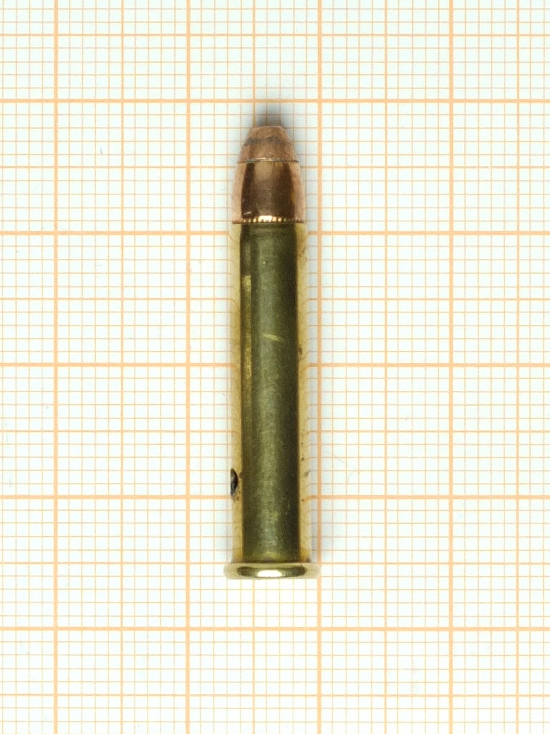Figure 3 — A .22 WMR cartridge. The case is 0.44 in longer than a .22 LR's, the bullet is jacketed rather than bare lead, and the two will not interchange in either direction — see Volume 2 §2.3, because gett…