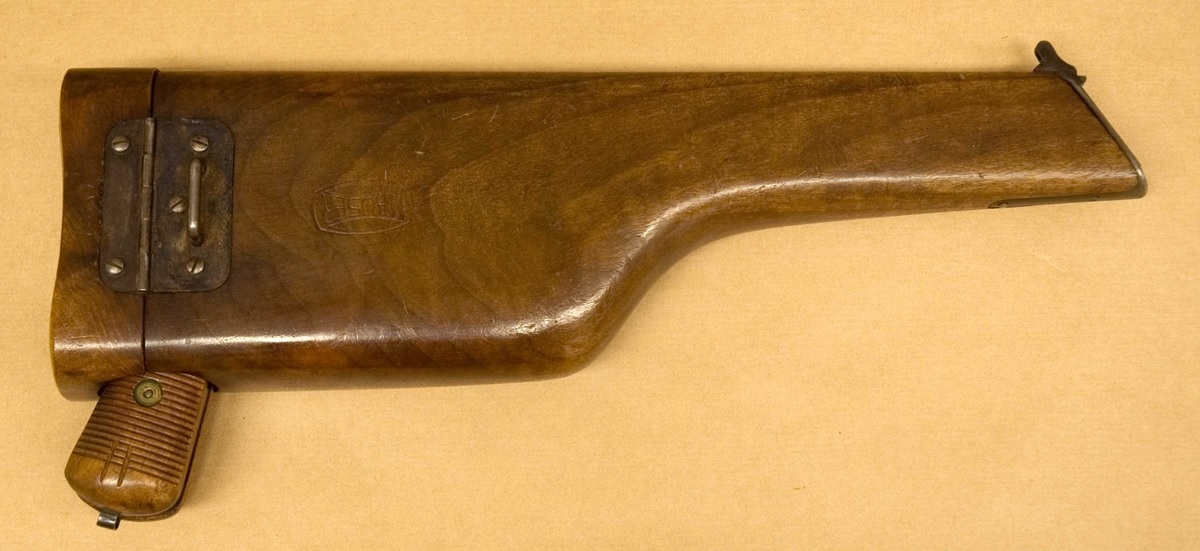 Figure 3.5 — A Mauser C96 stored in its wooden case-buttstock (Swedish Army Museum collection, donated by collector Gösta Benckert). The wooden case attaches to the rear of the grip frame via a met…