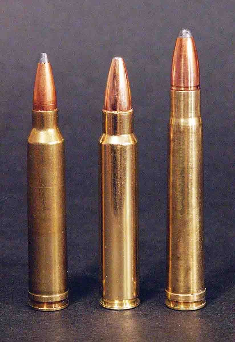 Figure 3 — Three belted magnum cartridges standing on end. The raised band just ahead of the extractor groove is the whole locating feature — the shoulder further up the case is doing nothing. Source: handloa…