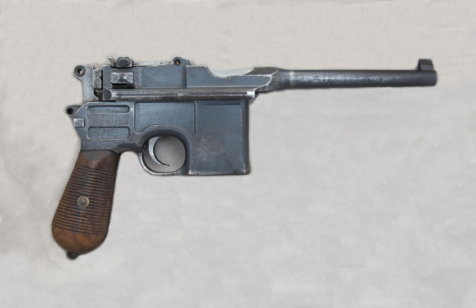 Figure 5.1 — Right-side receiver of a 7.63 mm C96 (SN 60403). The maker/address marking sits on the chamber top and the rear-panel area, with proof and inspection marks alongside; reading these aga…