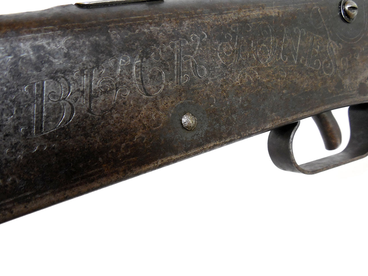 Figure 3 — The winner, marked: "BUCK JONES" engraved in scrollwork across the receiver of a No. 107 Model 36. The name on the frame and the compass in the stock belong to the same gun, and neither belongs to …