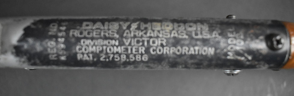 Figure 3 — A barrel marking from the Heddon era, rolled in four lines: "DAISY/HEDDON", "ROGERS, ARKANSAS, U.S.A.", "DIVISION VICTOR COMPTOMETER CORPORATION", and a patent number. This is the corporate identit…