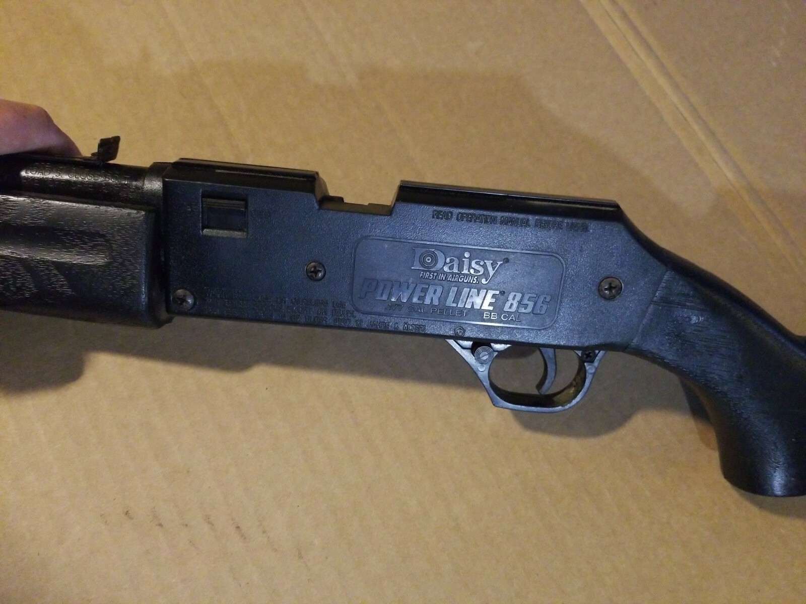 Figure 2 — The left receiver of a Powerline 856, the moulded rollmark reading "POWER LINE 856" over ".177 CAL PELLET  BB CAL". That second line settles the question the slot was asking: this example is the du…