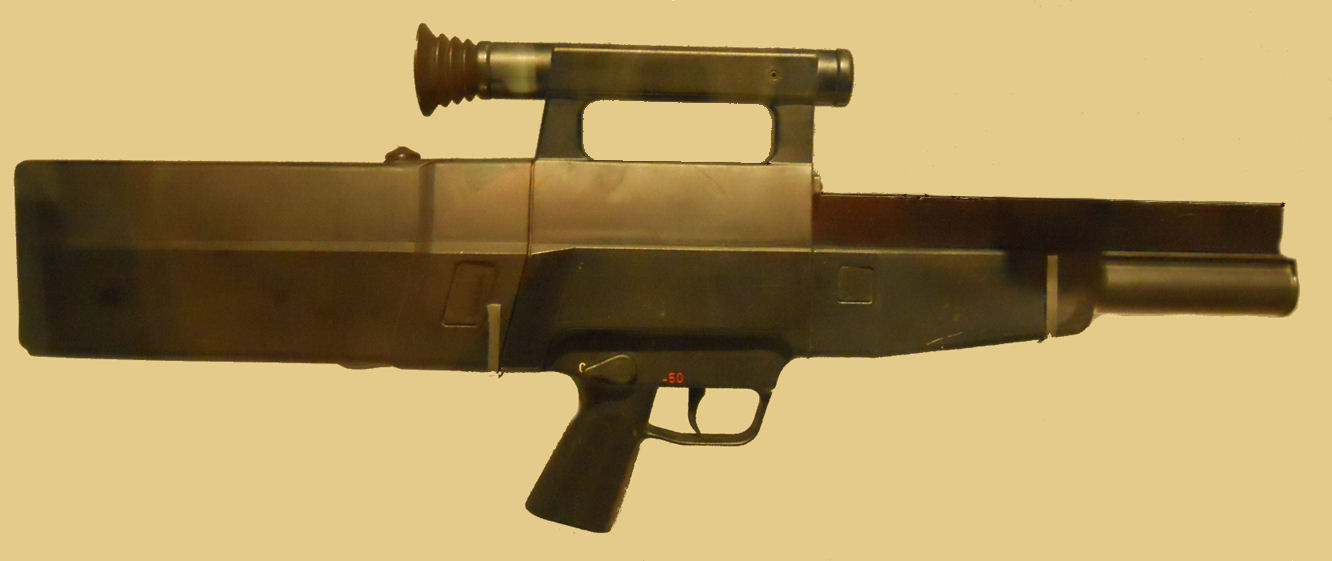Figure 5 — The Heckler und Koch G11, full profile. Almost nothing on the outside reads as a rifle: the slab-sided housing encloses a rotating breech that indexed each caseless block through ninety degrees bef…
