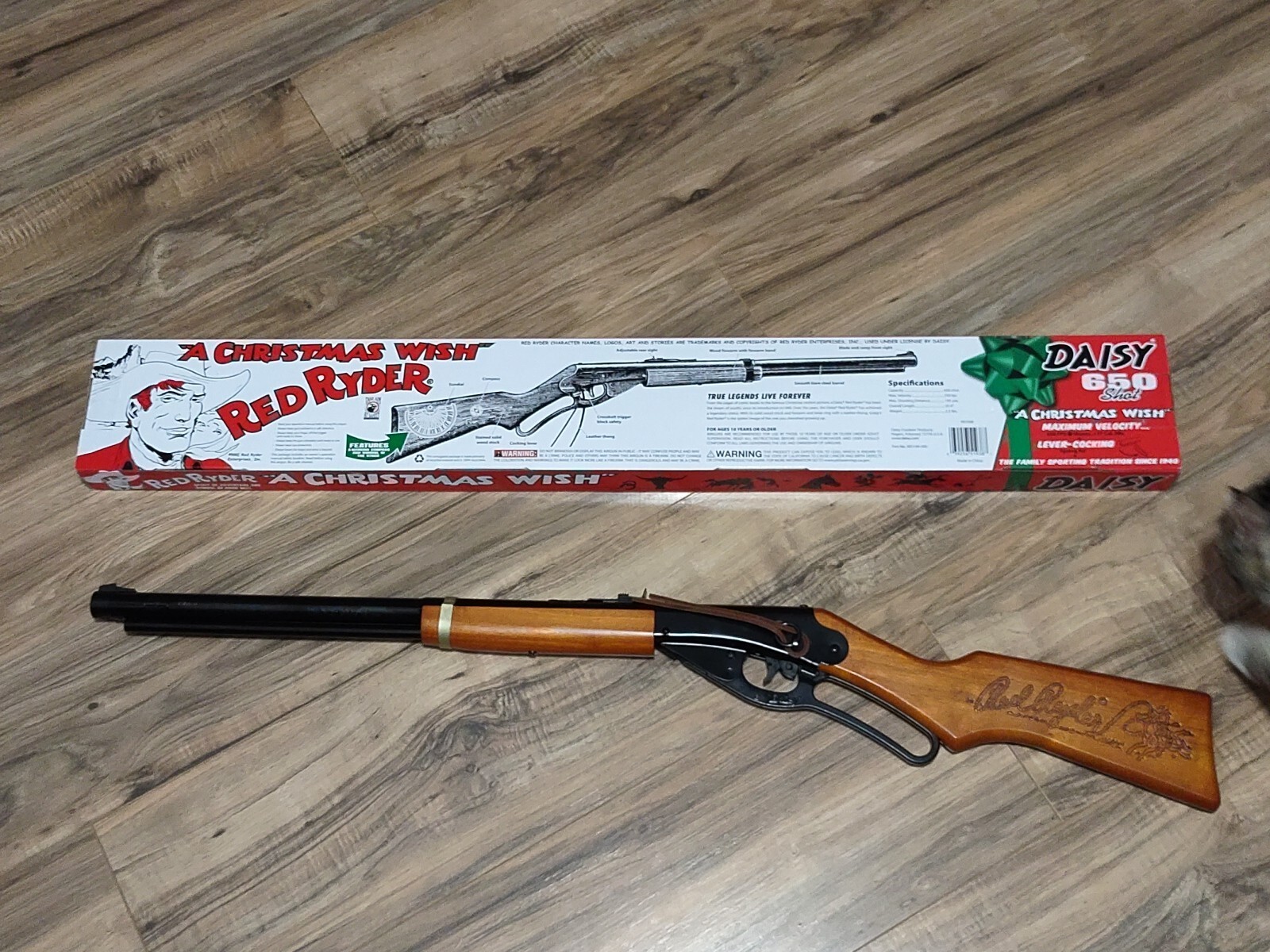 Figure 5 — The same edition boxed, the carton printed "A CHRISTMAS WISH" with Red Ryder artwork. The box carries no year, and the edition has run in more than one season, so this is captioned by model rather …