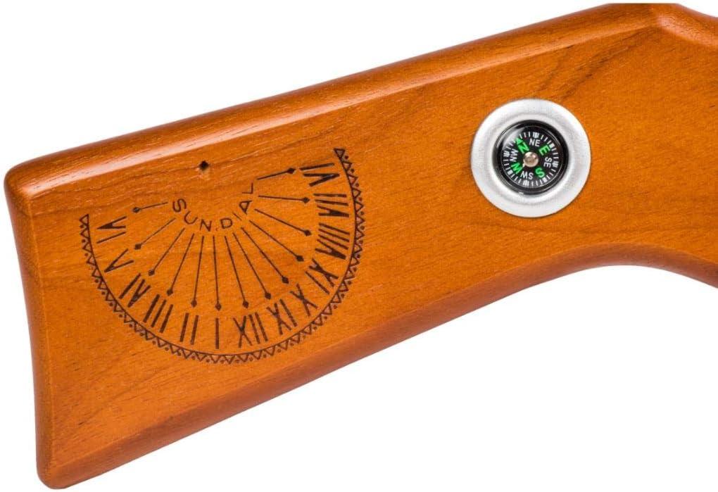 Figure 4 — The stock treatment itself, on a current "A Christmas Wish" carbine: an engraved sundial with Roman numerals and a raised gnomon, and beside it a real inset compass with a floating needle. Two thin…