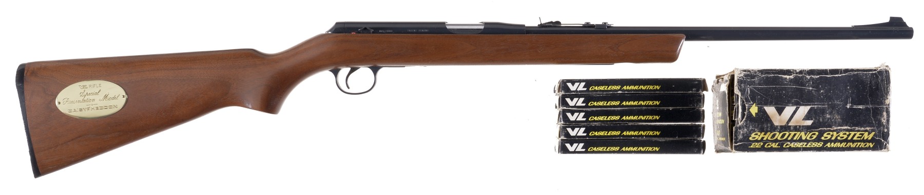 Figure 3 — The $125 Presentation Model: American walnut stock, brass plaque let into the right side of the butt for an owner's inscription, shown cased with the thousand rounds of caseless ammunition that cam…