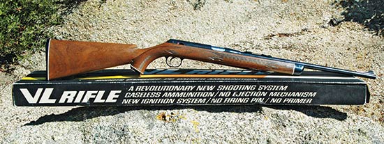 Figure 7 — The V/L lying on its retail box sleeve, which sells the gun on what it does not contain: the printed copy advertises a shooting system with no firing pin and no primers. That is Daisy explaining co…