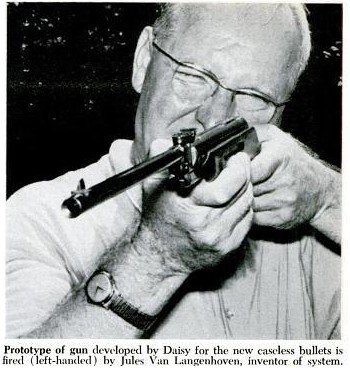 Figure 1 — The only located photograph of Jules Van Langenhoven: a press image of the inventor firing a Daisy-built prototype of the caseless rifle, shot left-handed, with the original agency caption printed …