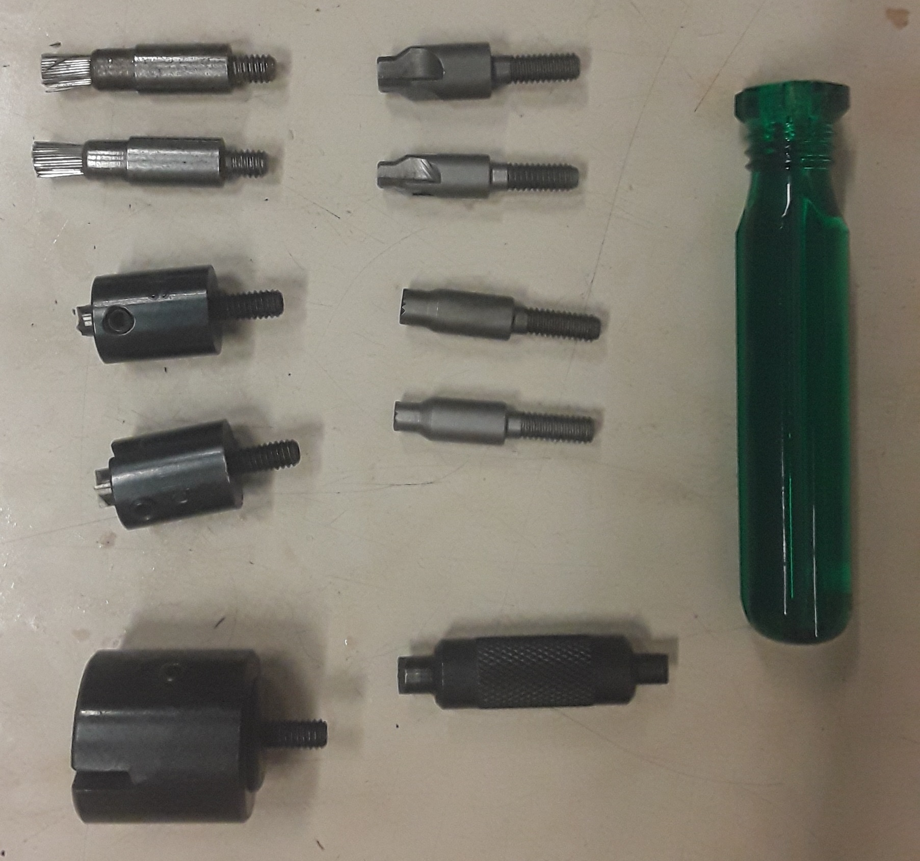 Figure 2 — An assortment of primer-pocket tooling laid out, which is what sorting and preparing pockets physically involves at the bench rather than in the abstract. Photograph by Wallpep, CC BY-SA 4.0, via W…
