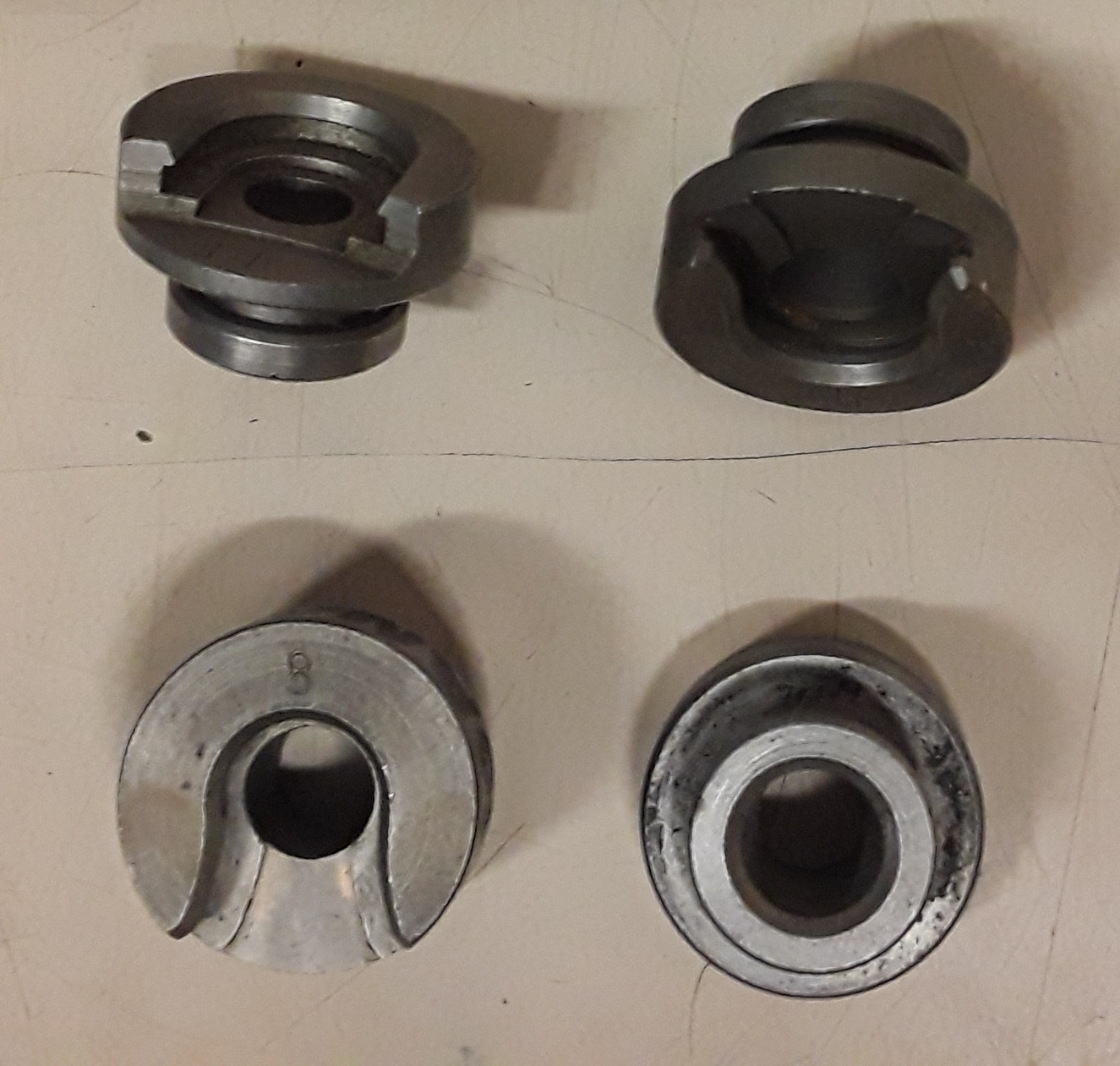 Figure 3 — One standard shell holder photographed from four angles. It is a small component that sets the case's position in the press, and therefore one that can quietly move a die setting. Photograph by Wal…