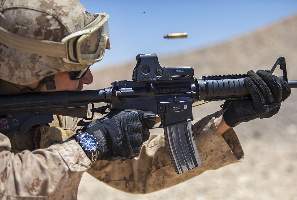 Figure 3 — A US Marine firing an M4 with an EOTech holographic weapon sight. Source: commons.wikimedia.org.