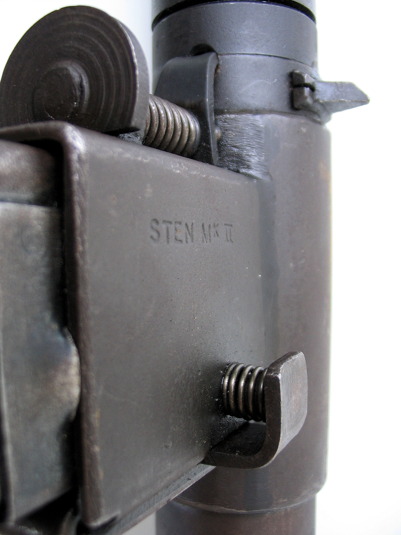 Figure 3.2 — A close-up of the Mk II magazine-well-to-receiver attachment (Polish museum specimen, same gun as Figure 1.1). The bare-steel STEN aesthetic is fully visible: the wrapped-and-welded re…