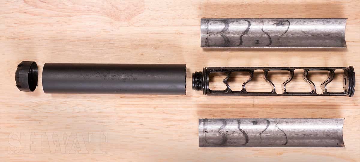 Figure 4 — A take-apart suppressor opened out: tube, end cap, and the core withdrawn. This is what §3.4's 'one part in, one part out' actually looks like on the bench. Source: web, reference use.